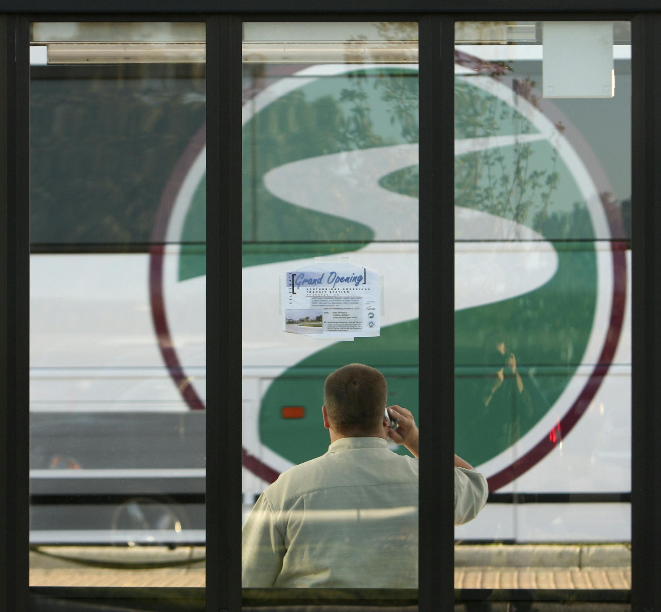 A man waits in a bus shelter as a Shakopee Transit BlueXpress bus arrived at the new Southbridge Crossings Transit Station in Shakopee Wednesday afternoon. GENERAL INFORMATION: JEFF WHEELER • jwheeler@startribune.com SHAKOPEE - 10/3/07 - A grand opening celebration was held Wednesday for the new Southbridge Crossings Transit Station in Shakopee. The bus service into Minneapolis and back has been up and running for three months, but on Wednesday local tranist officials greeted commuters wi
