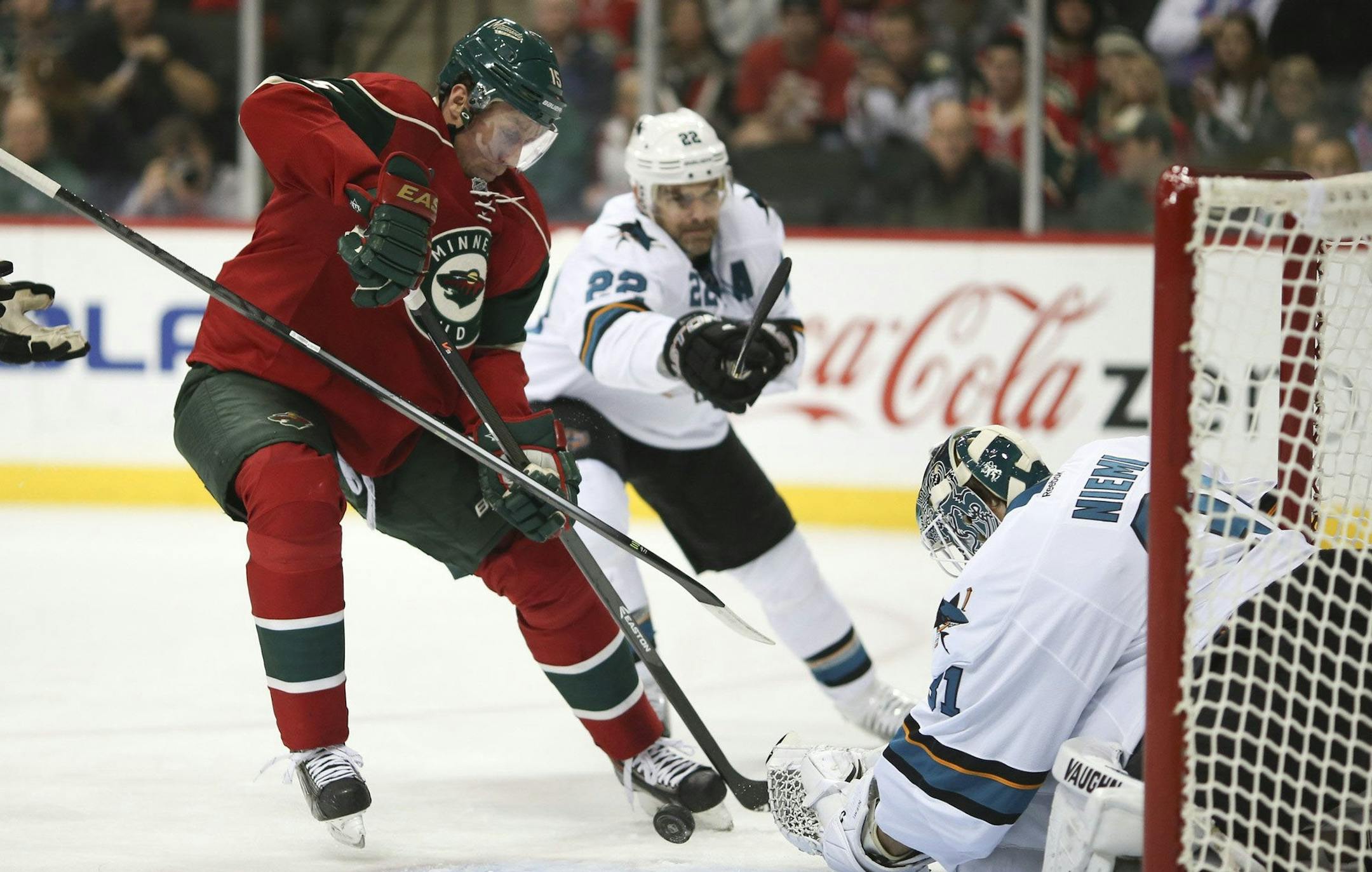Minnesota Wild left wing Dany Heatley (15) tries to stuff the puck past San Jose Sharks goalie San Jose Sharks goalie Antti Niemi (31) and San Jose defenseman Matt Irwin (52) in the first period at the Xcel Energy Center in St. Paul, Minn., on Sunday, Dec. 8, 2013. (Jeff Wheeler/Minneapolis Star Tribune/MCT)