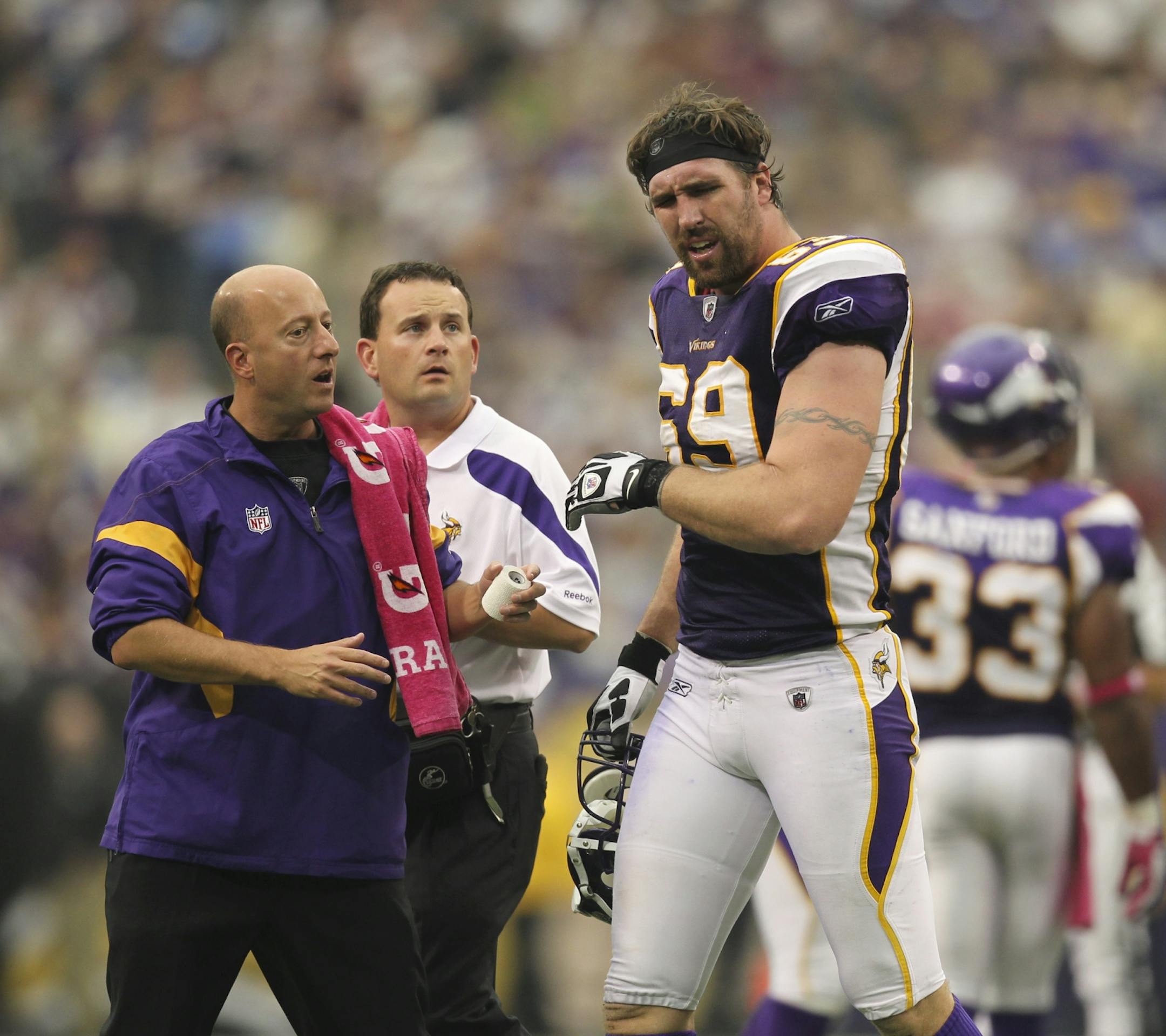 Vikings' defensive end Jared Allen walked off the field with head athletic trainer Eric Sugarman, left, after he was poked in the eye on a third quarter play. He returned later in the quarter. The Minnesota Vikings won their first game of the season with a 34-10 win over the Arizona Cardinals Sunday afternoon, October 9, 2011, at Mall of America Field in Minneapolis, Minn.