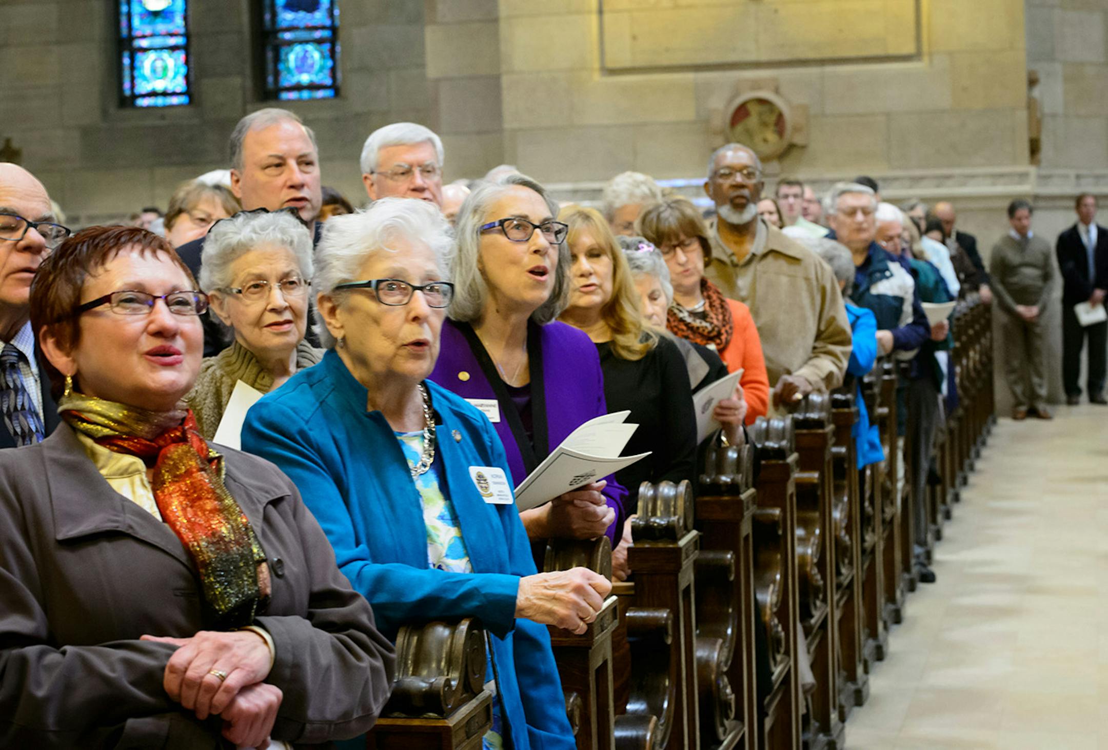 Singing the Gloria as Archbishop Bernard Hebda took his seat at the cathedra or bishops throne on the altar and acknowledged the sustained applause from the crowd.