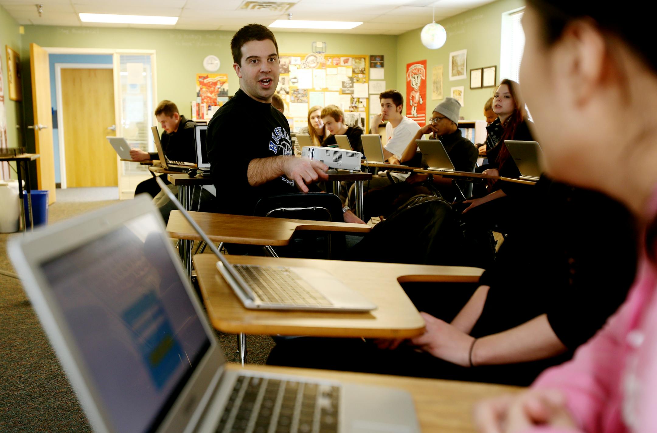 North Lakes Academy teacher Eric Nelson (right) spoke to his students about the Winter Olympics as they were watching a video on the history of the Olympics. Forest Lake, MN on February 11, 2014.