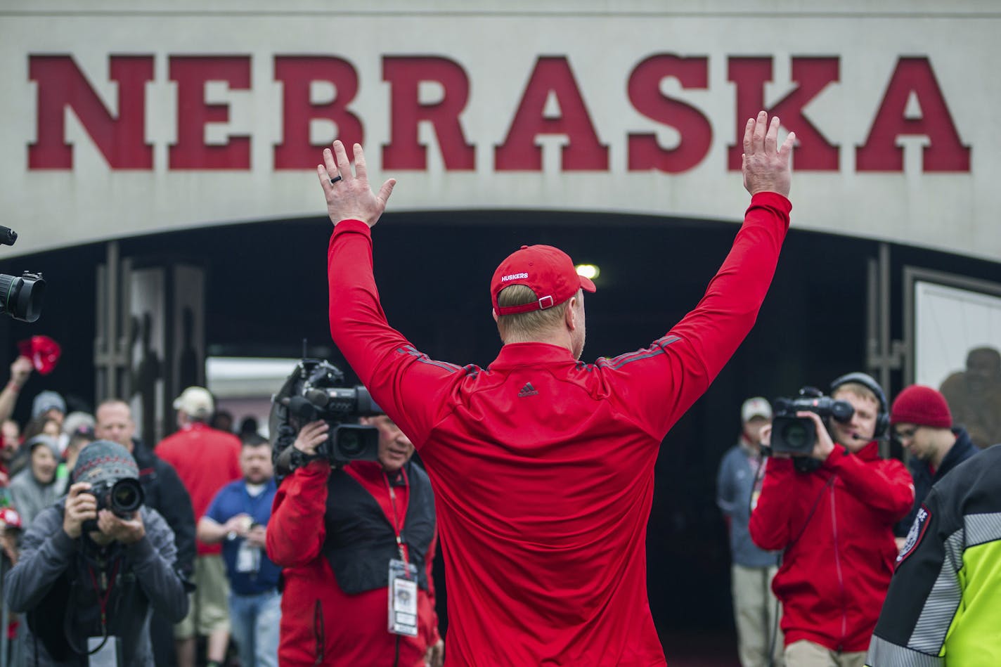 Nebraska head coach Scott Frost waves to the fans while walking off the field during the spring football game in Lincoln, Neb., Saturday, April 21, 2018.