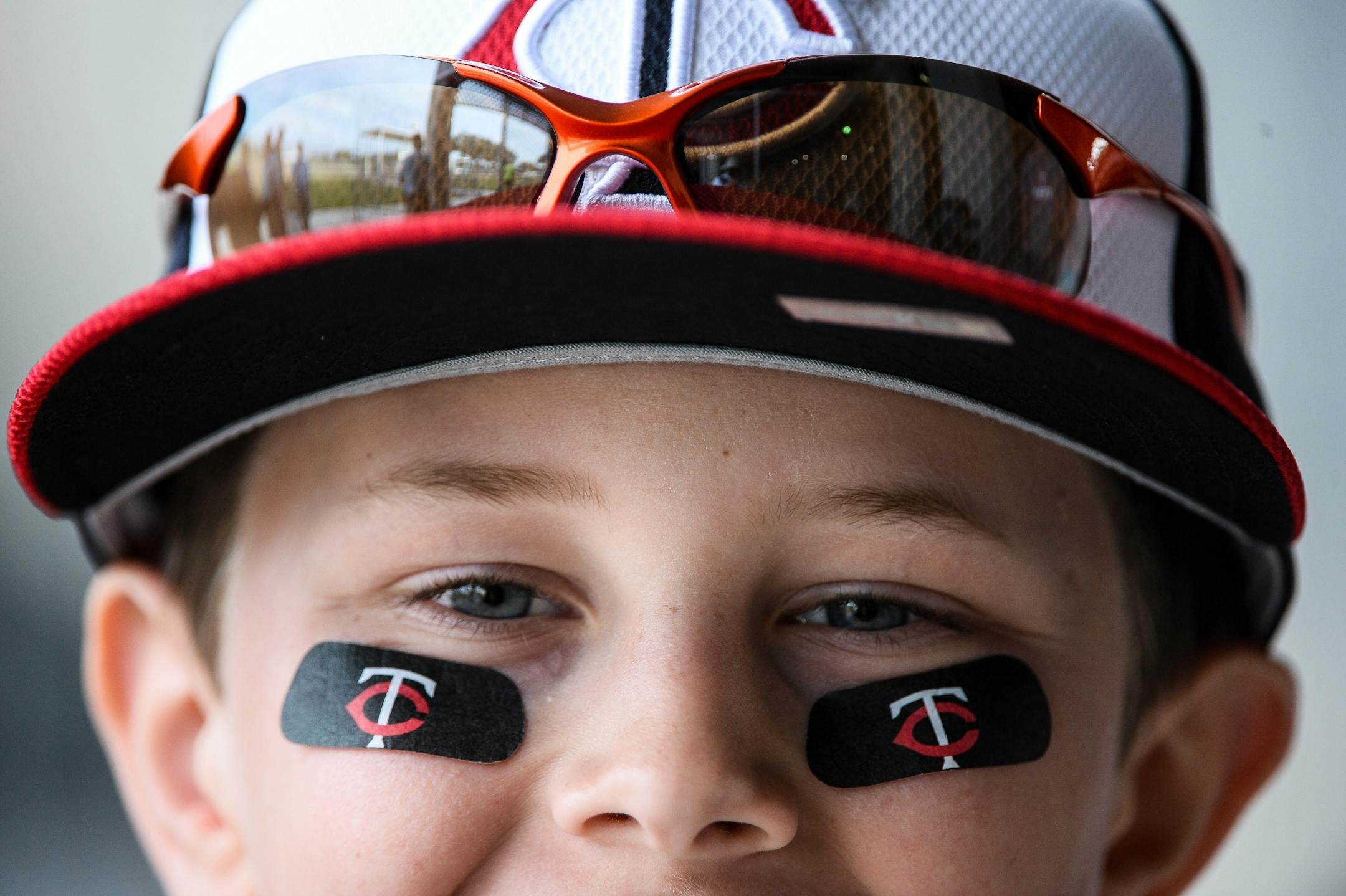 Brenden Brichacek, 10, of Crystal, wore Twins eye black as he waited for autographs Saturday outside Hammond field.