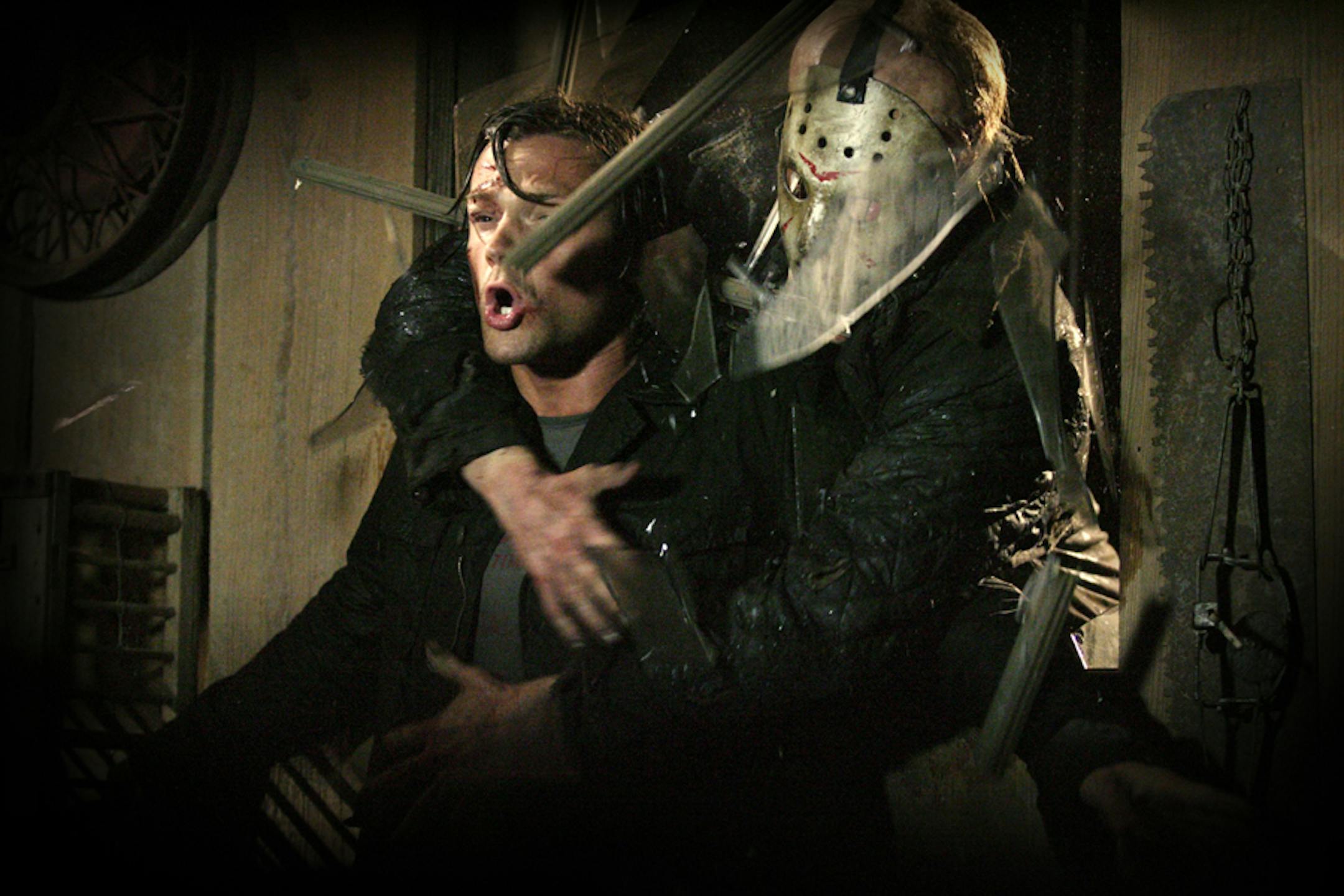 Jason (Derek Mears, right) crashes through a window and grabs Clay (Jared Padalecki, left) in "Friday the 13th."