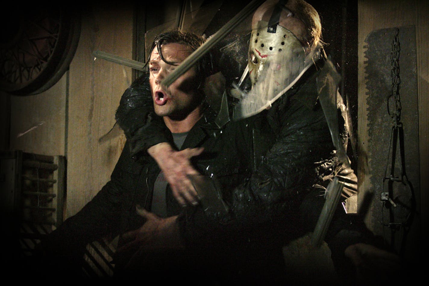 Jason (Derek Mears, right) crashes through a window and grabs Clay (Jared Padalecki, left) in "Friday the 13th."