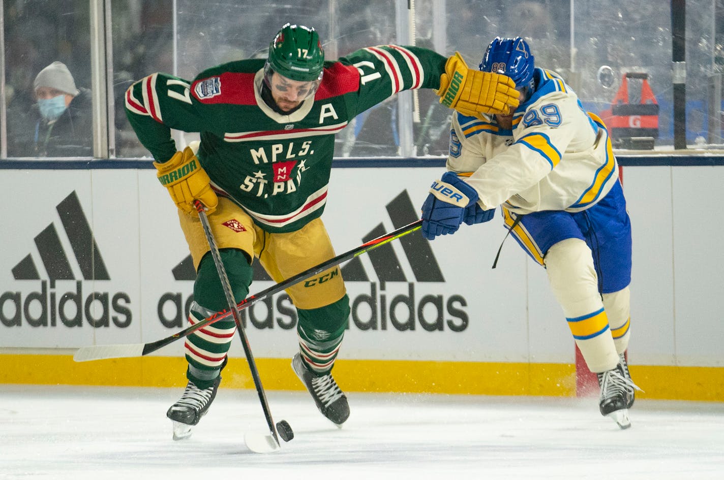 Minnesota Wild left wing Marcus Foligno (17) throws his hand in the face of St. Louis Blues left wing Pavel Buchnevich (89) in the third period of 2022 Winter Classic Saturday, Jan. 01, 2022 in Minneapolis, Minn. ]