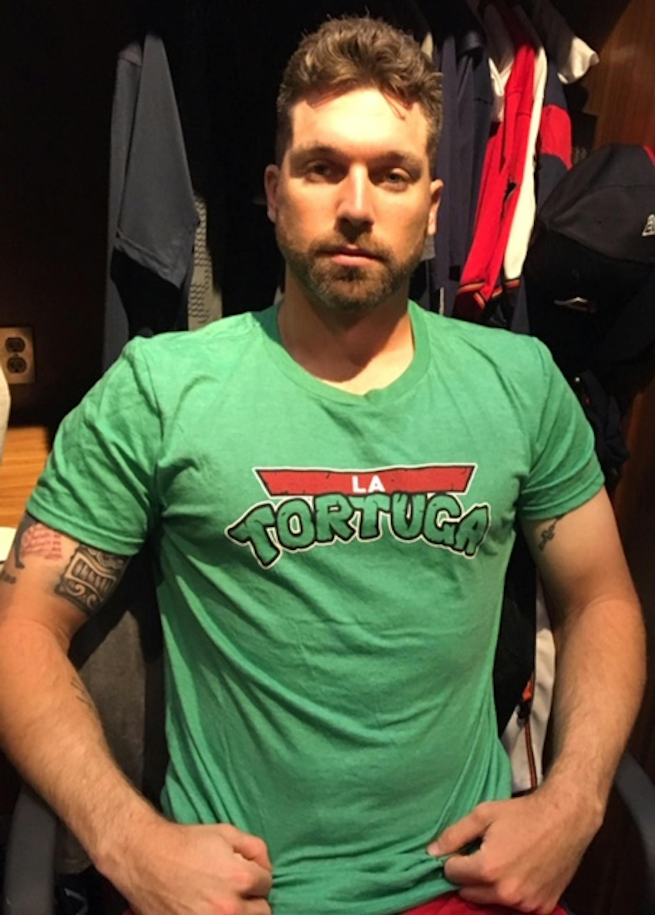 Jake Cave models "La Tortuga" t-shirt in honor of teammate Willians Astudillo.