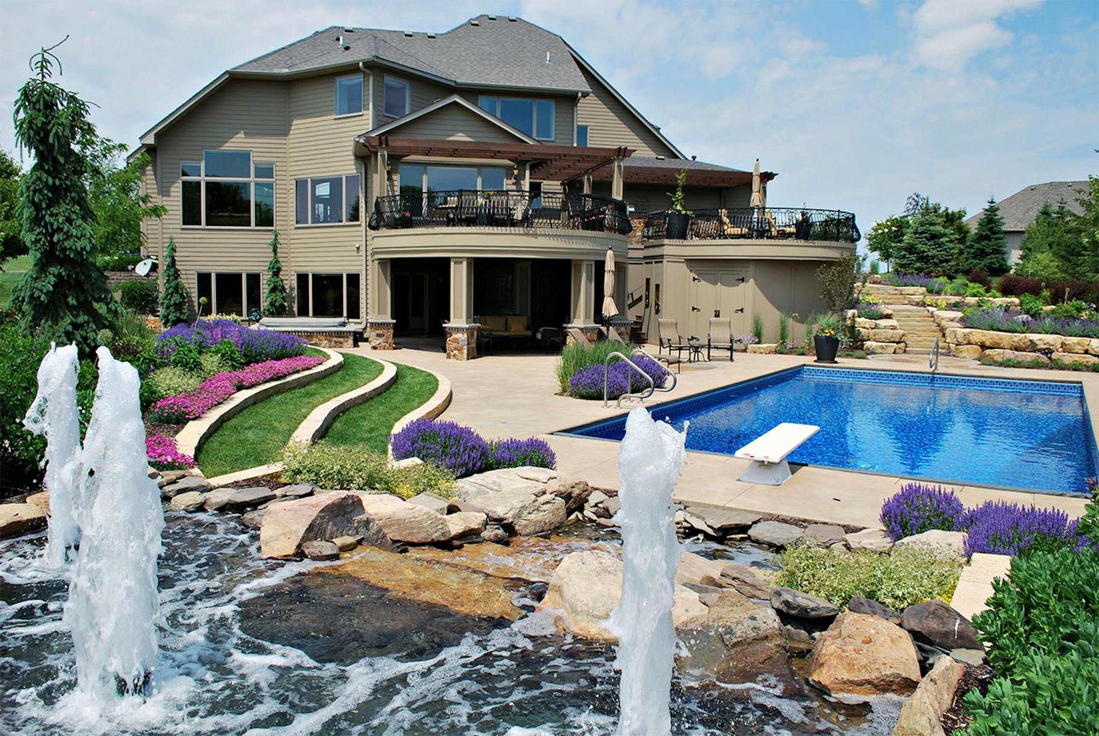 A water feature is near the pool.