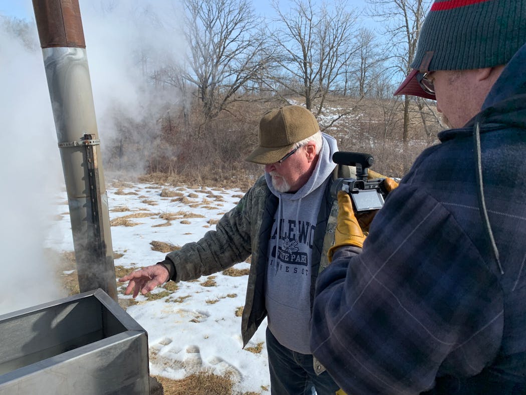 Bob Hanson, head of the annual maple sap boil at Maplewood State Park, explained the process as Erik Osberg captured video.