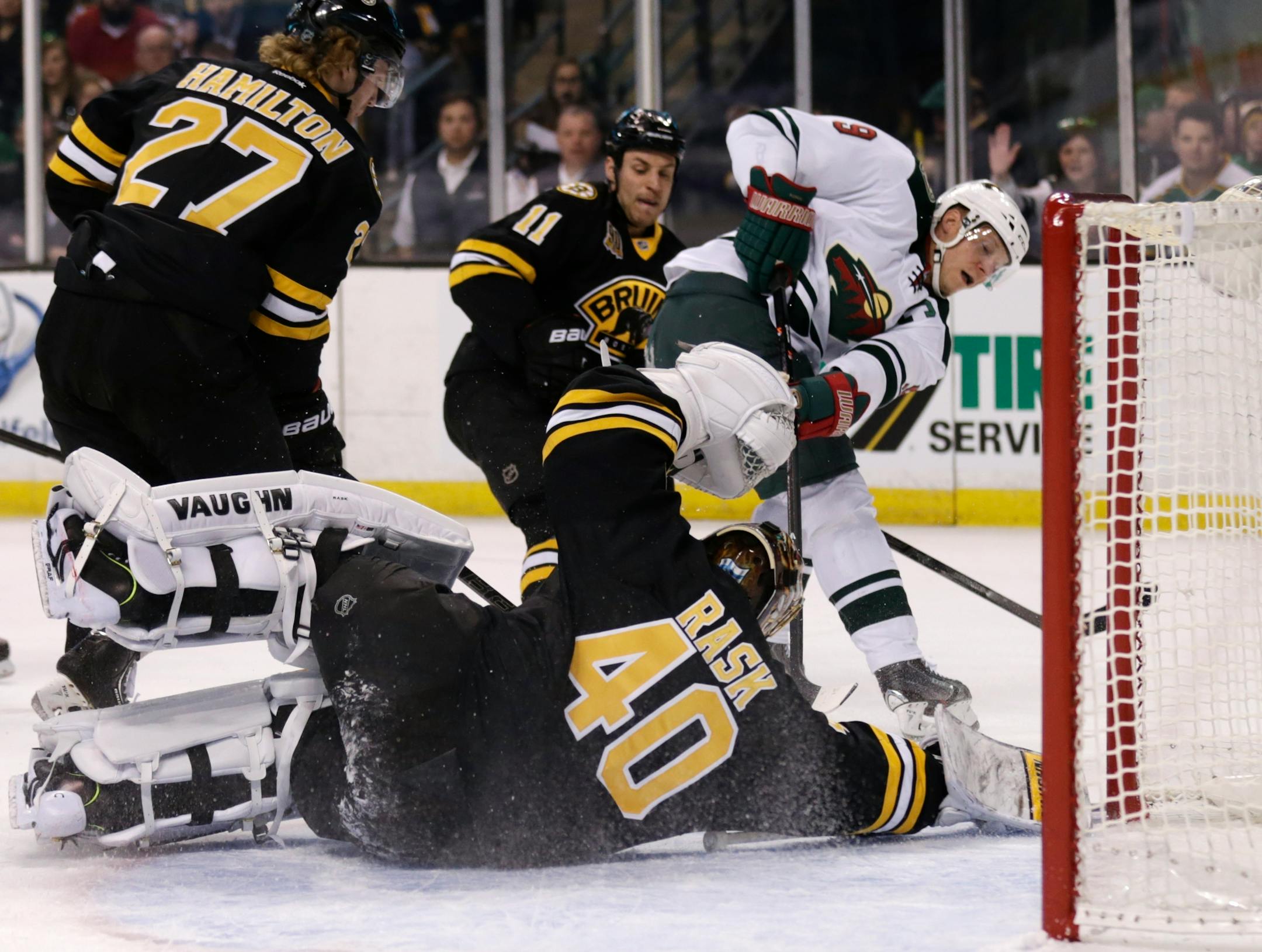 Boston Bruins goalie Tuukka Rask dropped to the ice to make a save on a shot by Wild center Mikko Koivu (9).