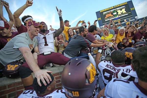 Gophers players and fans celebrated with the Little Brown Jug after defeating Michigan 30-14 on Saturday in Ann Arbor, Mich.