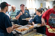 Bill Miller gave a thumbs-up to a fellow firefighter about the taste of the smelt at a fundraiser for the Jump River Volunteer Fire Department. Wiscon