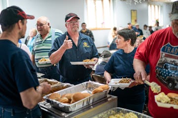 Bill Miller gave a thumbs-up to a fellow firefighter about the taste of the smelt at a fundraiser for the Jump River Volunteer Fire Department. Wiscon