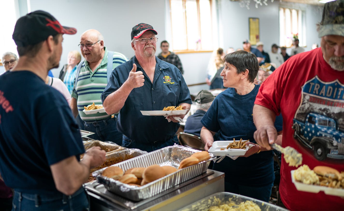 Bill Miller gave a thumbs-up to a fellow firefighter about the taste of the smelt at a fundraiser for the Jump River Volunteer Fire Department. Wisconsin's Taylor County is a rural county with a low unemployment rate and a deep-red voting tradition.