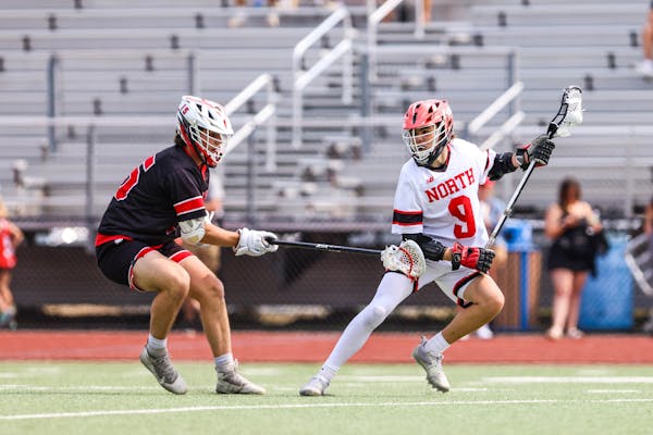 Lakeville North’s Blake Piscitiello looked for room to maneuver during a 9-8 overtime victory over Shakopee in the boys lacrosse semifinals at White