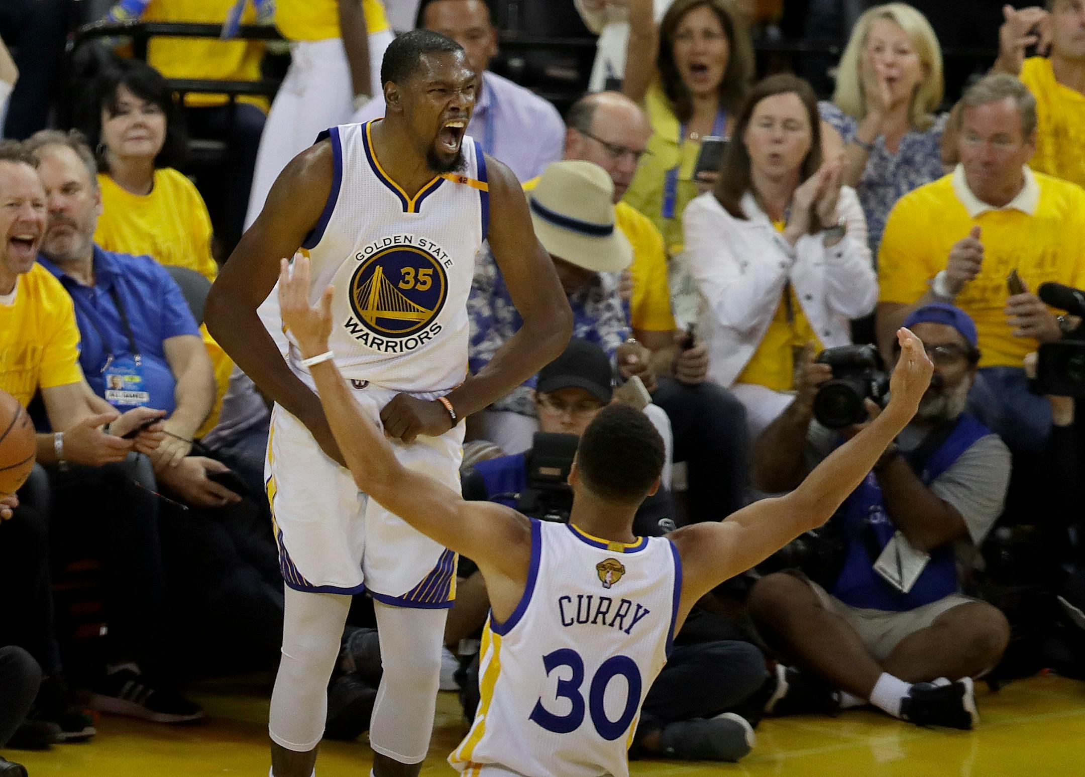 Golden State Warriors forward Kevin Durant (35) celebrated with guard Stephen Curry during the second half of Game 2 of the NBA Finals against the Cleveland Cavaliers.