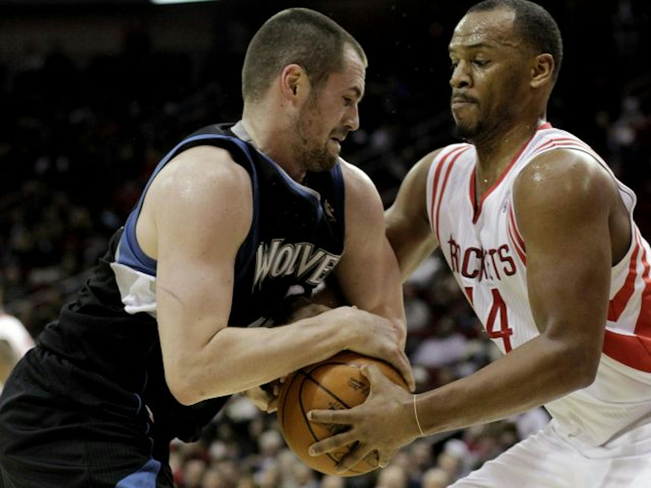Minnesota's Kevin Love, left, and Houston's Chuck Hayes battle for the ball.