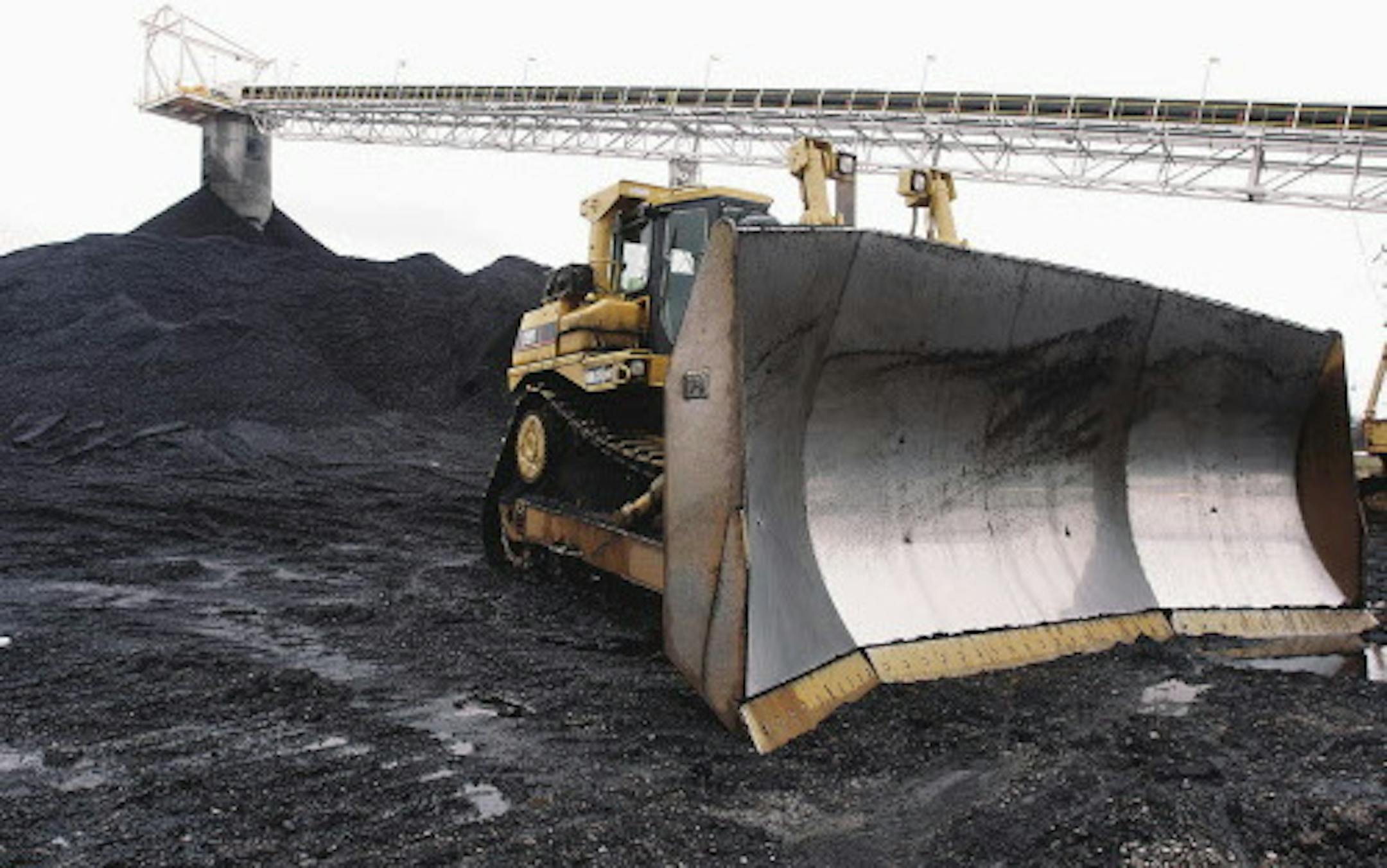 FILE - In this March 9, 2006, file photo, a large bulldozer sits ready for work at Peabody Energy's Gateway Coal Mine near Coulterville, Ill. At a time when the embattled coal industry is fighting economic and political challenges that threaten many jobs in central and southern Illinois, the state Attorney General's Office is considering legal action against the Illinois Department of Natural Resources for what prosecutors call a failure to follow the terms of a court-brokered plan to toughen ov