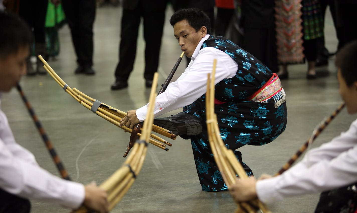 Johnny Lee, 20, danced as he played a traditional Hmong instrument called the quega at the RiverCentre during the Hmong New Year celebration.