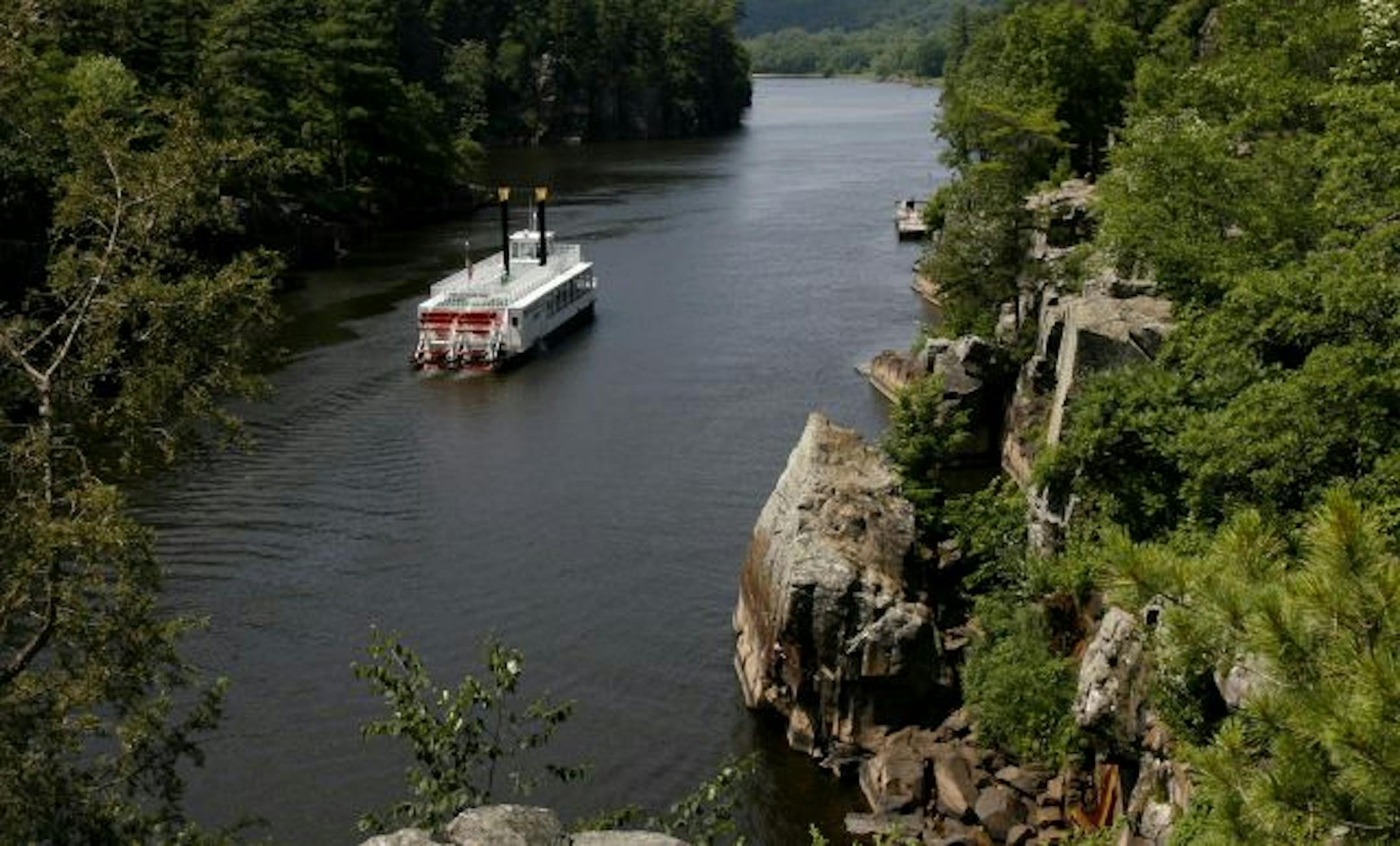A paddleboat floats down the St. Croix River through Interstate Park.