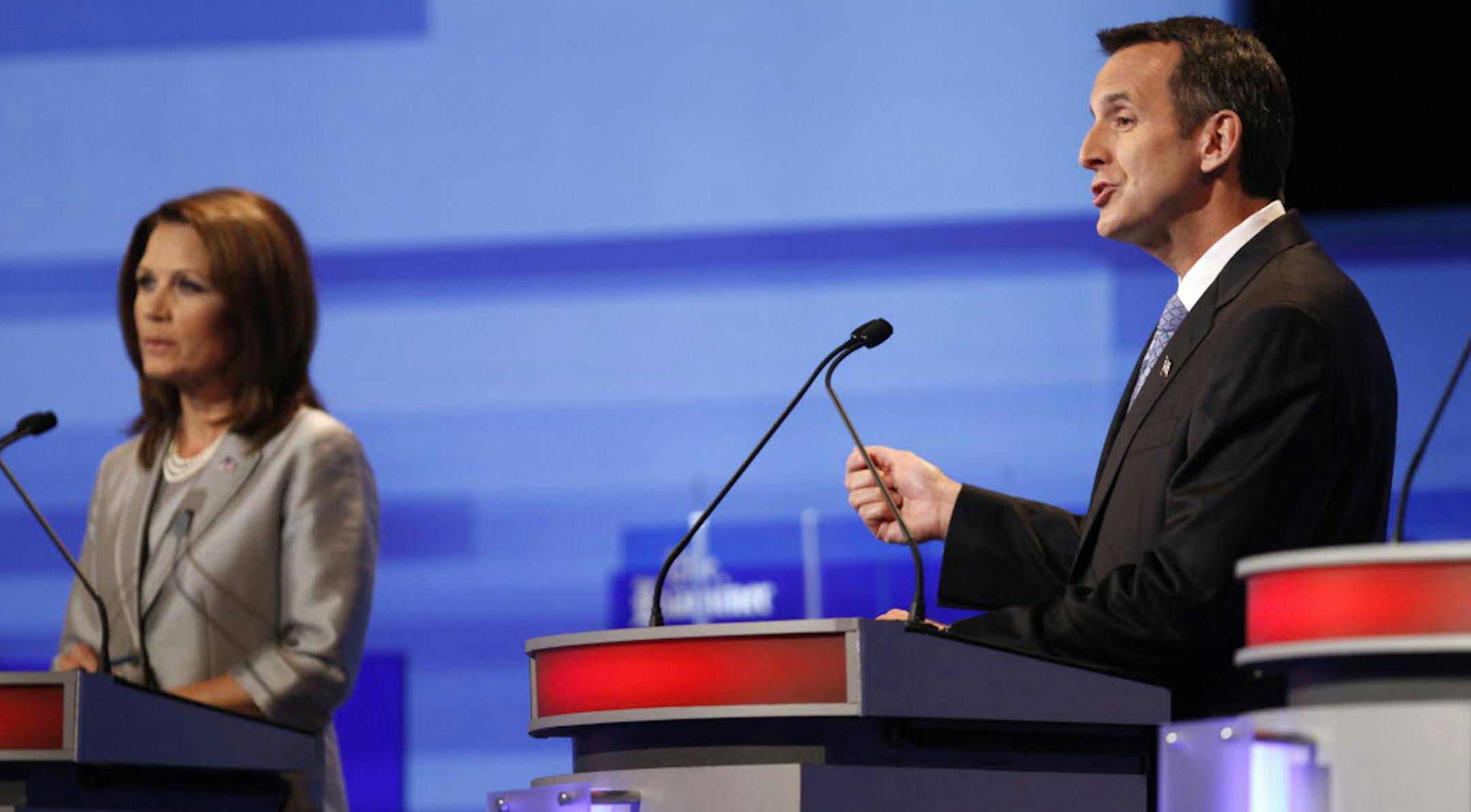 Tim Pawlenty speaks as Michele Bachmann listens during the Iowa GOP/Fox News Debate.