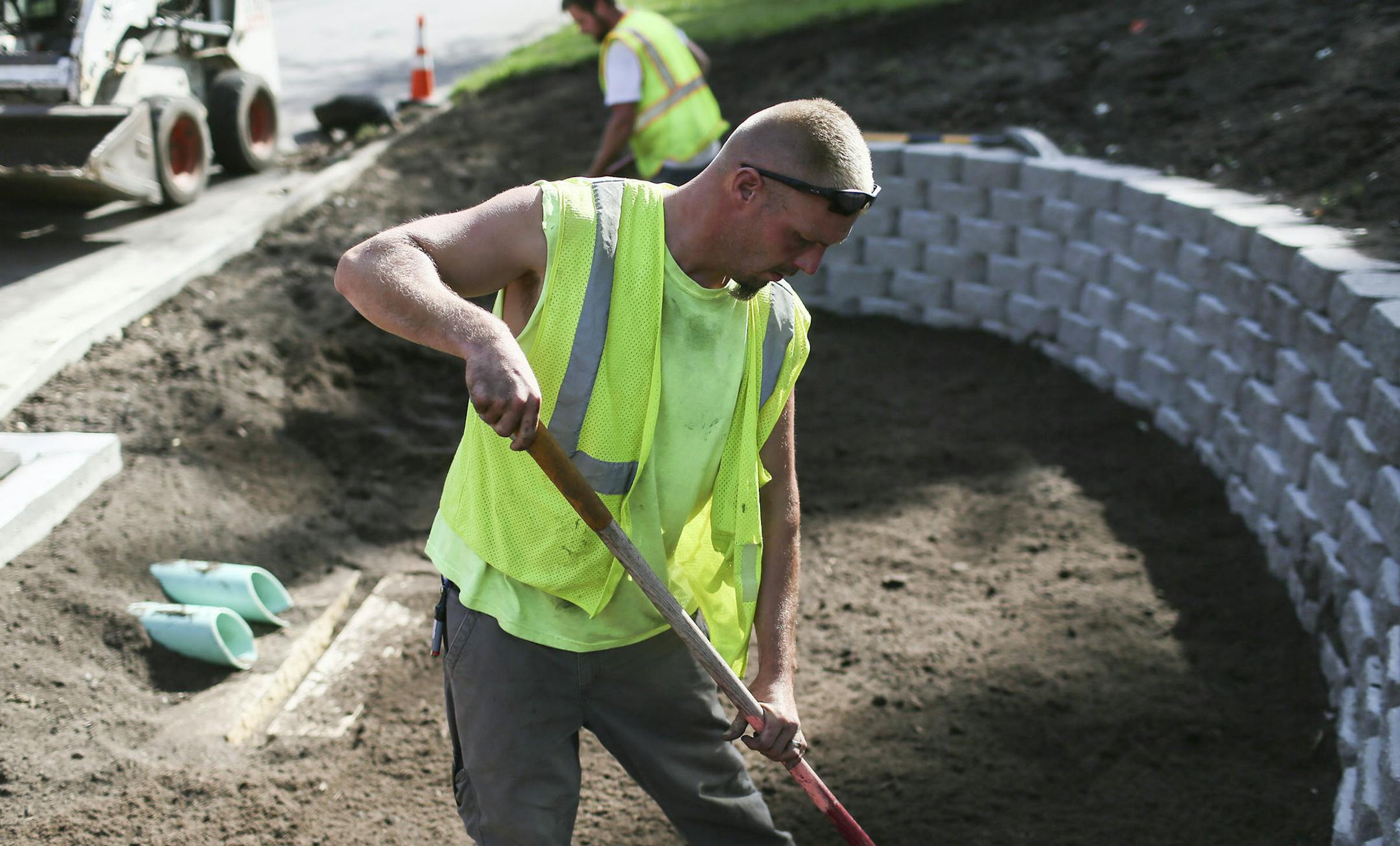 Workers for Urban Companies are finishing up work on Green Streets for Blue Waters project to create about 20 rain gardens throughout Bloomington - the rain gardens are designed to divert storm water from flowing into sewers and replenish groundwater. Here, Urban Companies employee Scott Nalipinski left soil on a project near the corner of W. 104th St. and Nicollet Ave. Wednesday, Aug. 27, 2014, in Bloomington, MN.] (DAVID JOLES/STARTRIBUNE) djoles@startribune City officials across the metro are