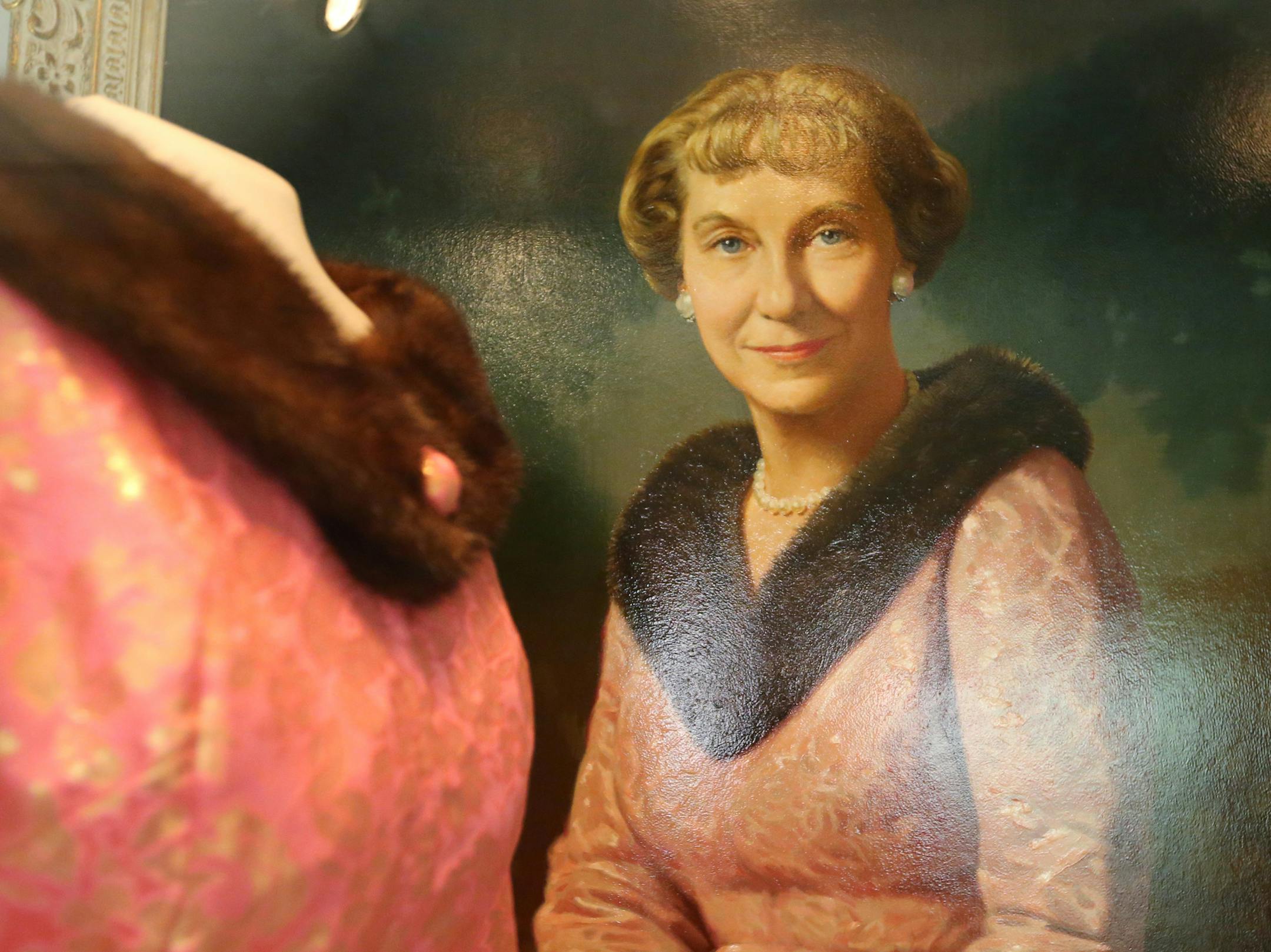 An oil painting of Mamie Eisenhower hangs beside the fur collared gown she wore for the portrait, at the Eisenhower Library on August 20, 2015, in Abeline, Kan. (Bo Rader/Wichita Eagle/TNS)