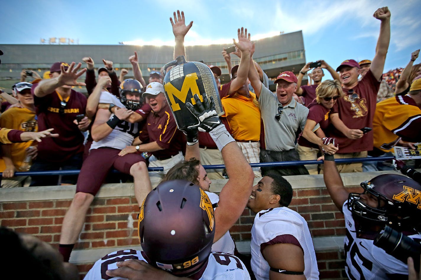 Gophers players and fans celebrated after winning the Little Brown Jug by beating Michigan in 2014.