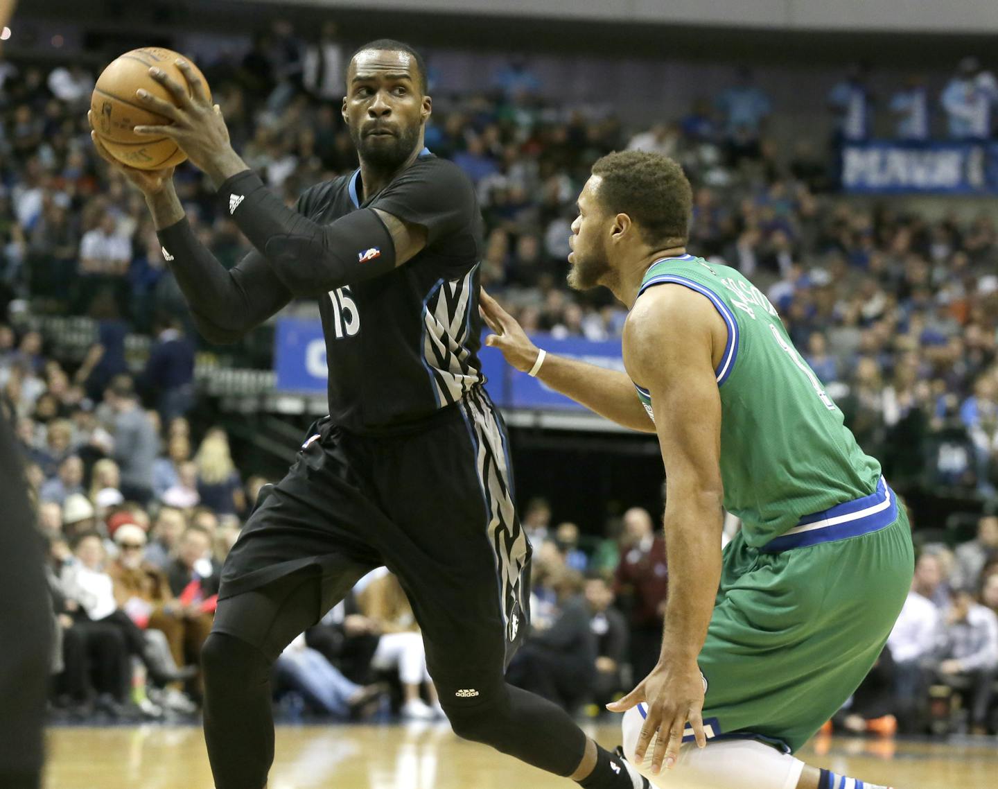 Minnesota Timberwolves forward Shabazz Muhammad (15) looks to pass against Dallas Mavericks guard Justin Anderson (1) during the first half of an NBA basketball game Wednesday, Jan. 20, 2016, in Dallas. (AP Photo/LM Otero)