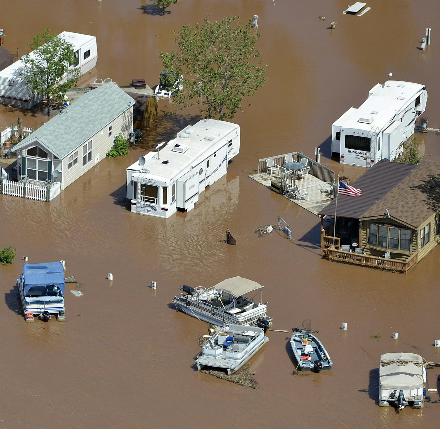 Water continues to rage in the St.Louis River as it flows through Jay Cooke State Park, washing out major sections of Hwy. 210 and ripping out the swinging bridge in the park. Here, trailers and boats float together along the St. Louis River at Gary New Duluth, in Minnesota, June 21, 2012. (Brian Peterson/Minneapolis Star Tribune/MCT)