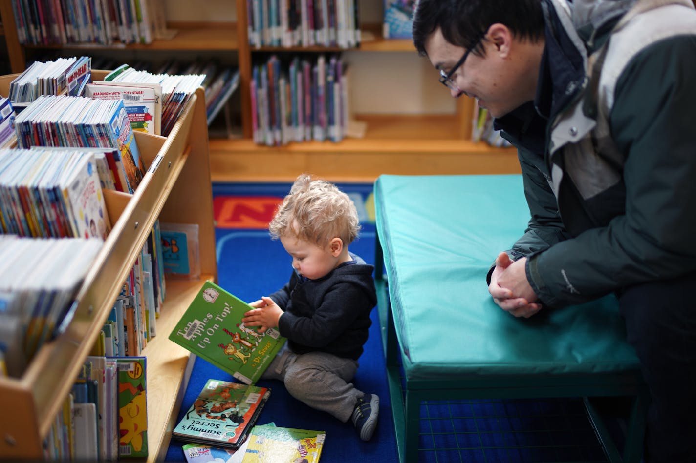 A year after St. Paul eliminated overdue fines at its libraries and forgave $2 million in late fees, there's new data showing a rise in people using the system. Here, Galen Kanazawa watched as his 18-month-old son Aiden pick out books at St. Paul's Riverview Library Thursday morning.
brian.peterson@startribune.com
St. Paul, MN Thursday, January 30, 2020