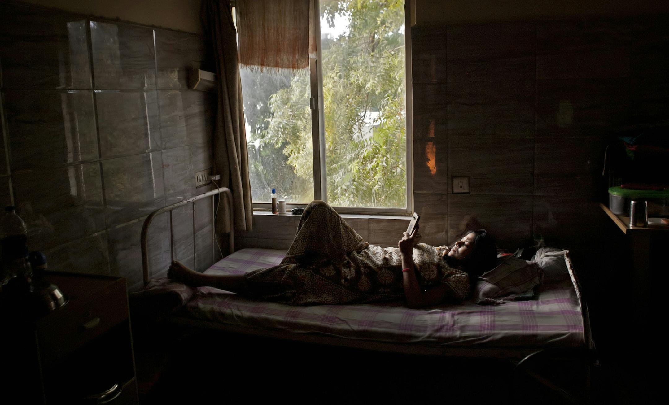In this Nov. 3, 2015 photo, 30-year-old Bhagwati Chauhan, who gave birth to a Canadian couple's child on Oct. 27, rests at the Akanksha Clinic, one of the most organized clinics in the surrogacy business, in Anand, India. Chauhan heard of the surrogacy program from her sister, who was also a surrogate. For thousands of childless couples the world over, India has been the go-to destination to fulfill their dreams of becoming parents, thanks to its well-trained doctors, well-appointed fertility cl