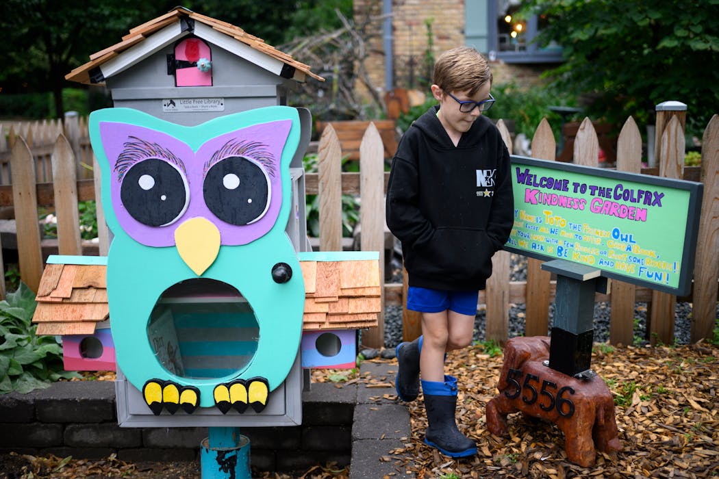 Graham Mekemson walks behind his family’s just-completed Little Free Library, still awaiting books and other attractions.
