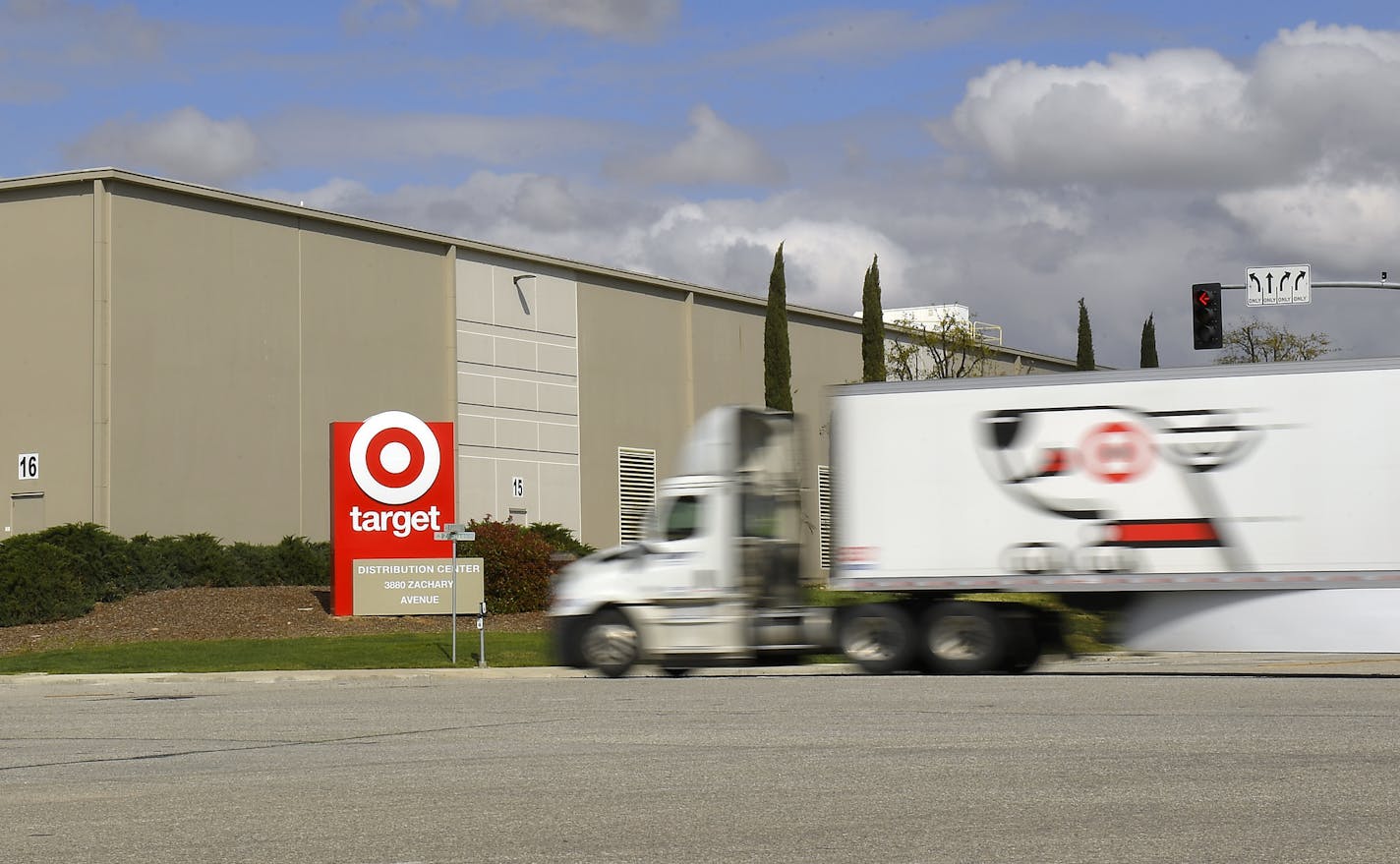 A semi truck drives toward a Target distribution center, Tuesday, March 24, 2020, in Shafter, Calif. (AP Photo/Mark J. Terrill)