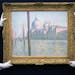 Sotheby's staff pose for a picture with 'Le Grand Canal' by Claude Monet, during a preview of their upcoming Impressionist and Modern, Surrealist and 
