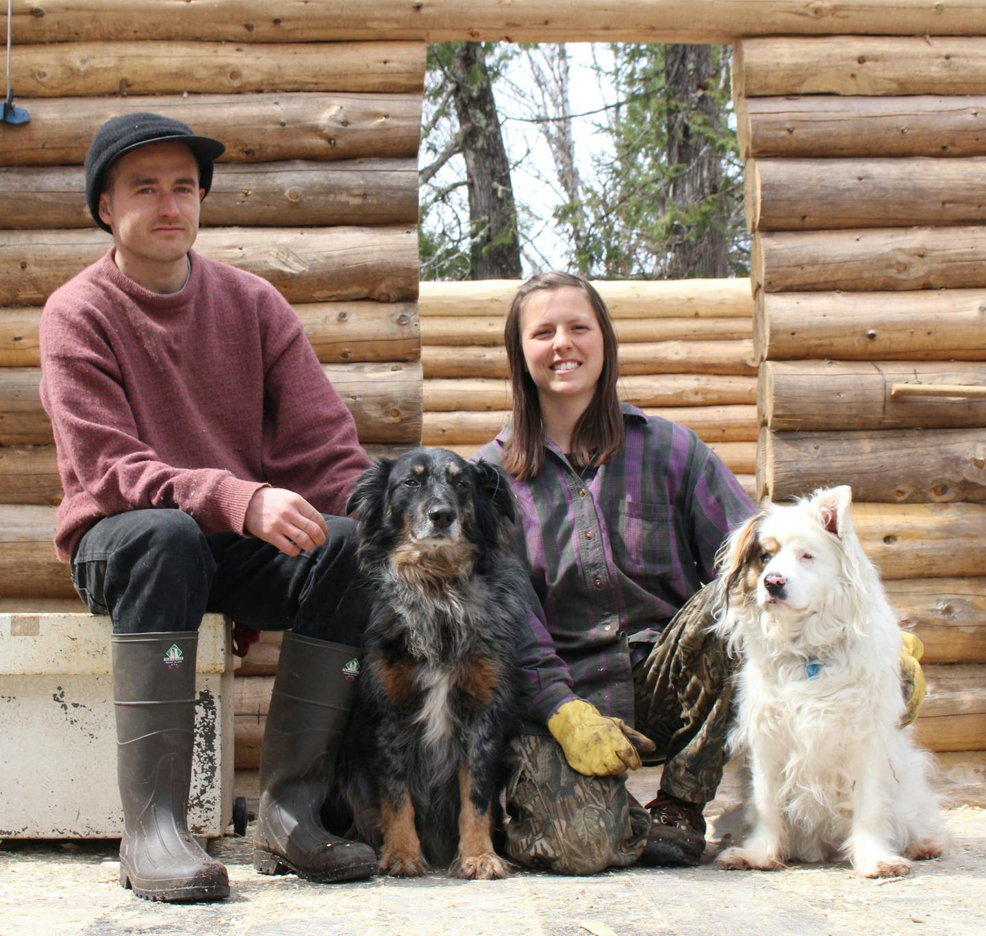 Micah and Christine take a break from construction for a family portrait on their workshop deck with their dogs Yucca (left) and Nefili (right).