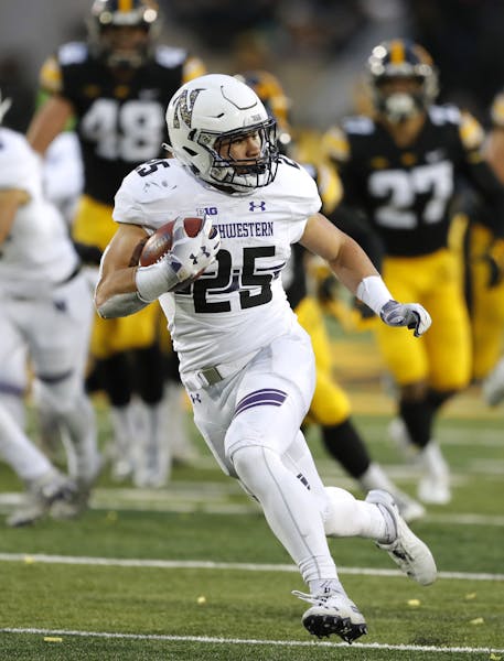 Northwestern running back Isaiah Bowser runs up field during a 34-yard touchdown run in the second half of an NCAA college football game against Iowa,