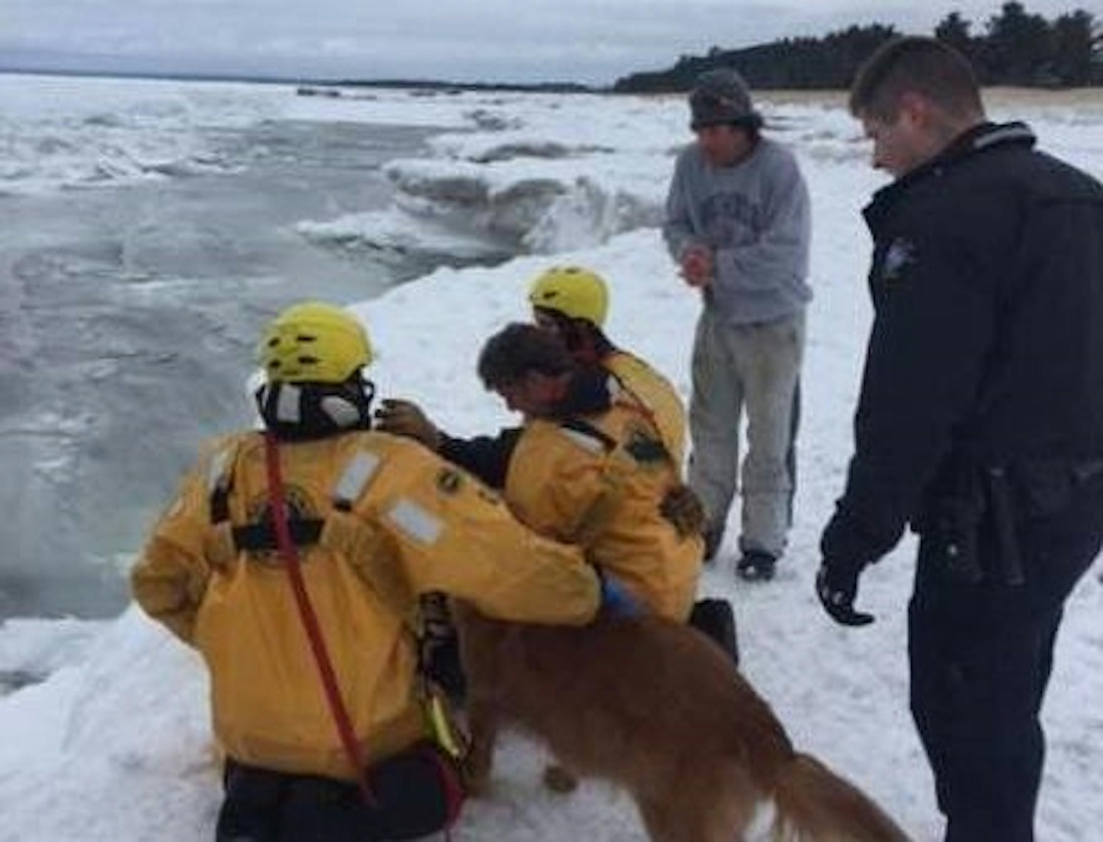 Rescuers tend to a woman pulled from Lake Superior.