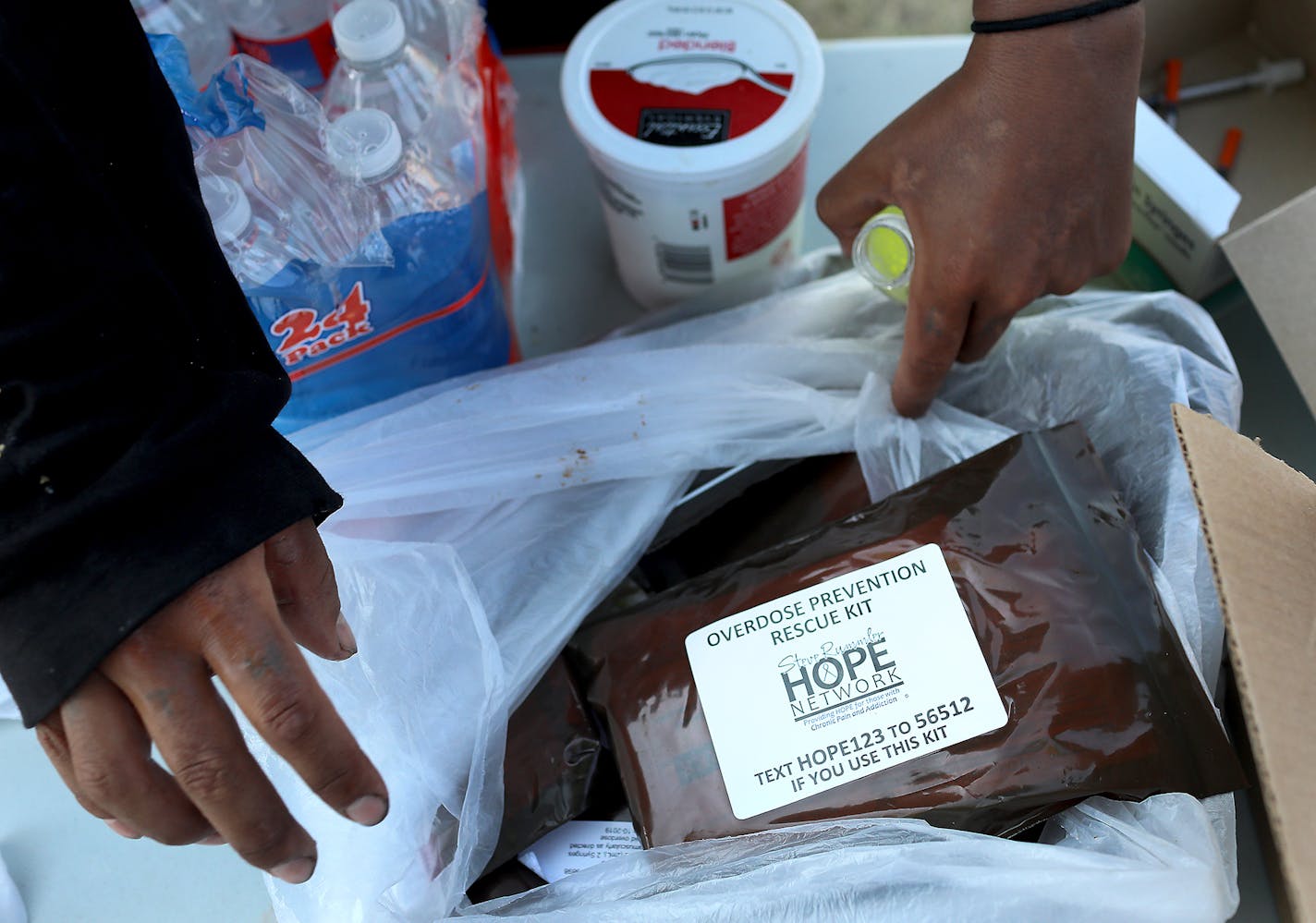 Bags of Narcan kits were also available in a dinner line sponsored by Natives Against Heroin at a homeless encampment near Hiawatha and Cedar Avenues Wednesday, Aug. 8, 2018, in Minneapolis.