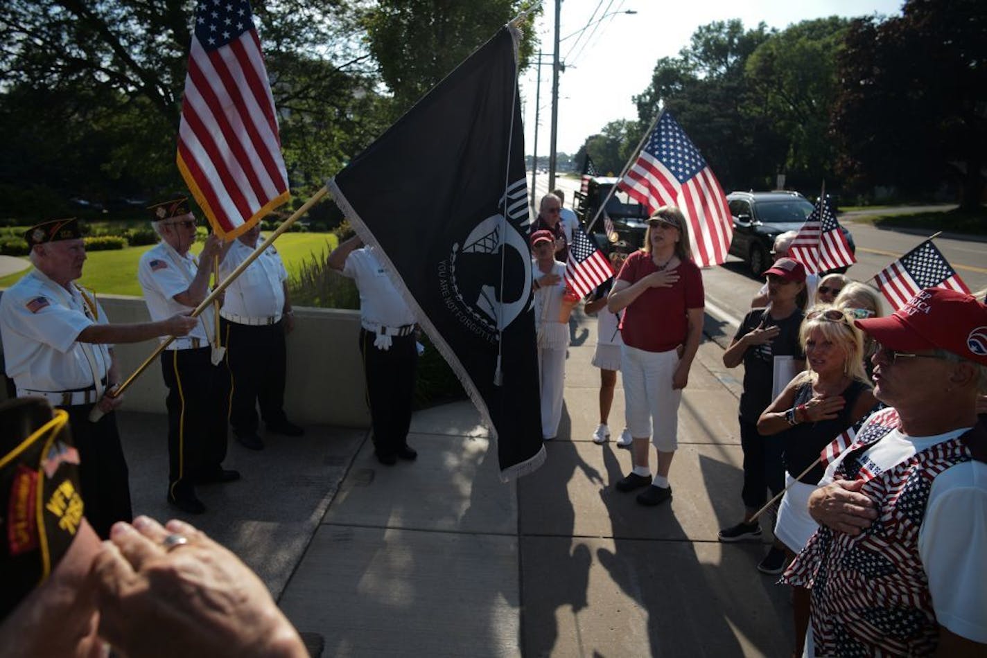 Supporters of the Pledge of Allegiance including veteran Kevin Murphy, far right, and members of VFW 7051 recited it together in front of St. Louis Park City Hall.