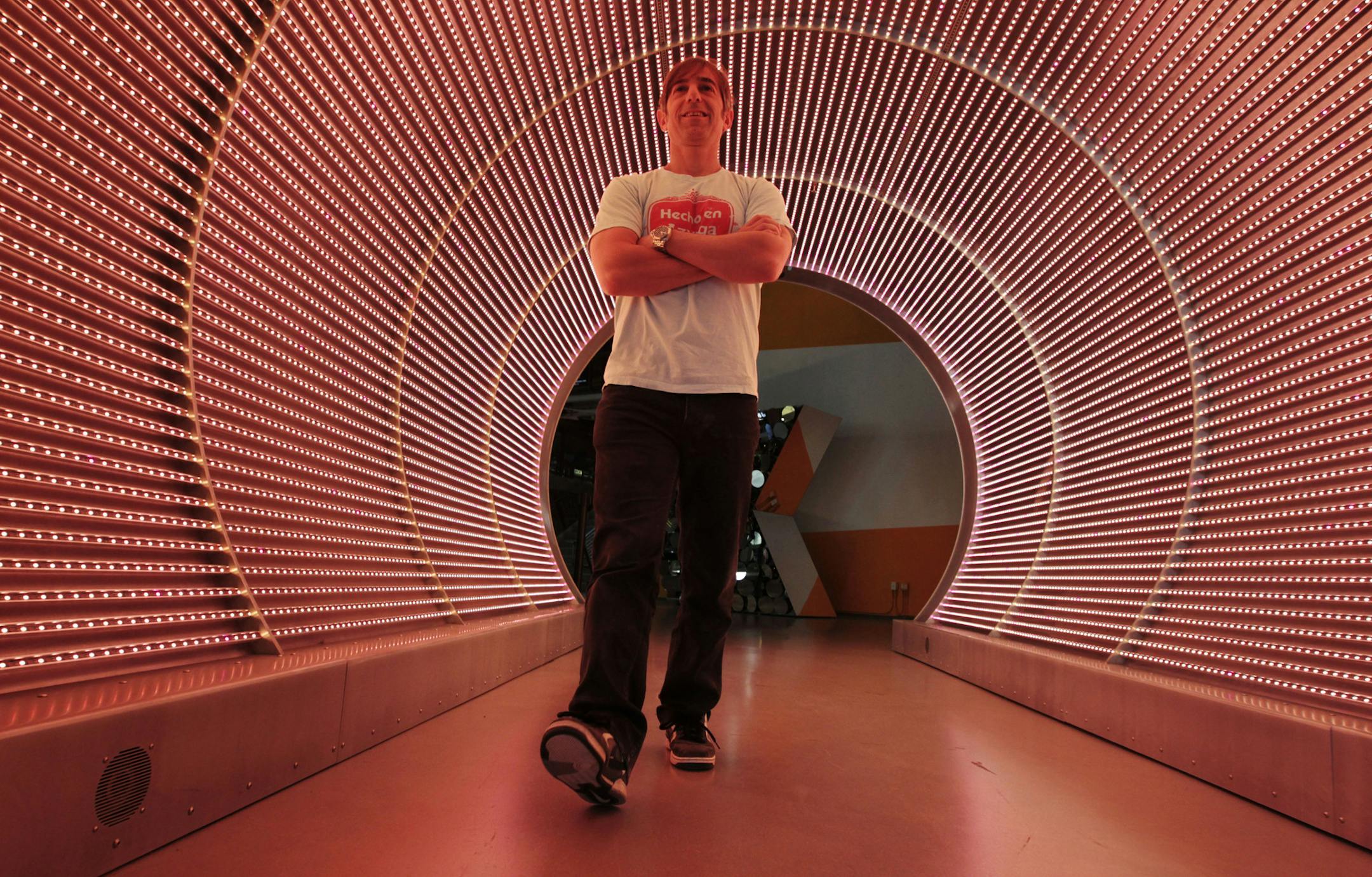 In this May 2, 2012 photo, Zynga CEO Mark Pincus walks through the "Time Tunnel" in the lobby of Zynga headquarters in San Francisco. Zynga Inc. reports quarterly financial results after the market closes Wednesday, April 24, 2013. (AP Photo/Paul Sakuma)