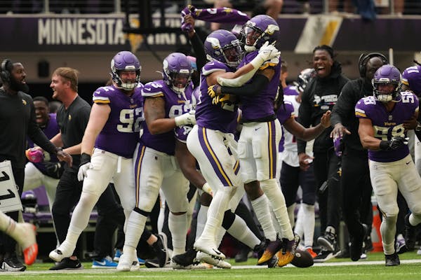 Vikings cornerback Cameron Dantzler, right, celebrates with teammate Camryn Bynum after after stripping the ball from Bears wide receiver Ihmir Smith-