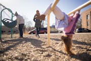 Catherine, left, and Julianna Sheridan play with their two kids at a playground. The couple are fighting to keep sole custody of their 5-year-old daug