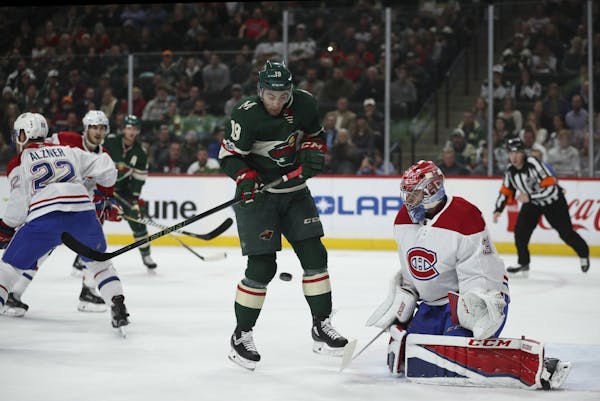 Wild center Luke Kunin tried to deflect an incoming shot in front of Montreal Canadiens goalie Carey Price in November.