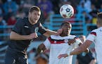 Minnesota United FC defender Justin Davis (2) and Atlanta Silverbacks defender Rauwshan McKenzie (2) make contact while going for a header in the firs