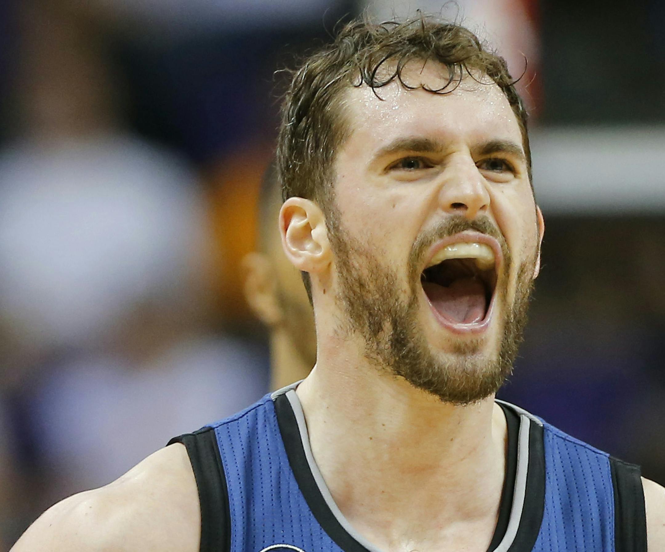 Minnesota Timberwolves forward Kevin Love (42) yells after hitting a three pointer against the Phoenix Suns during the second half of an NBA basketball game, Tuesday, Feb. 25, 2014, in Phoenix. (AP Photo/Matt York)