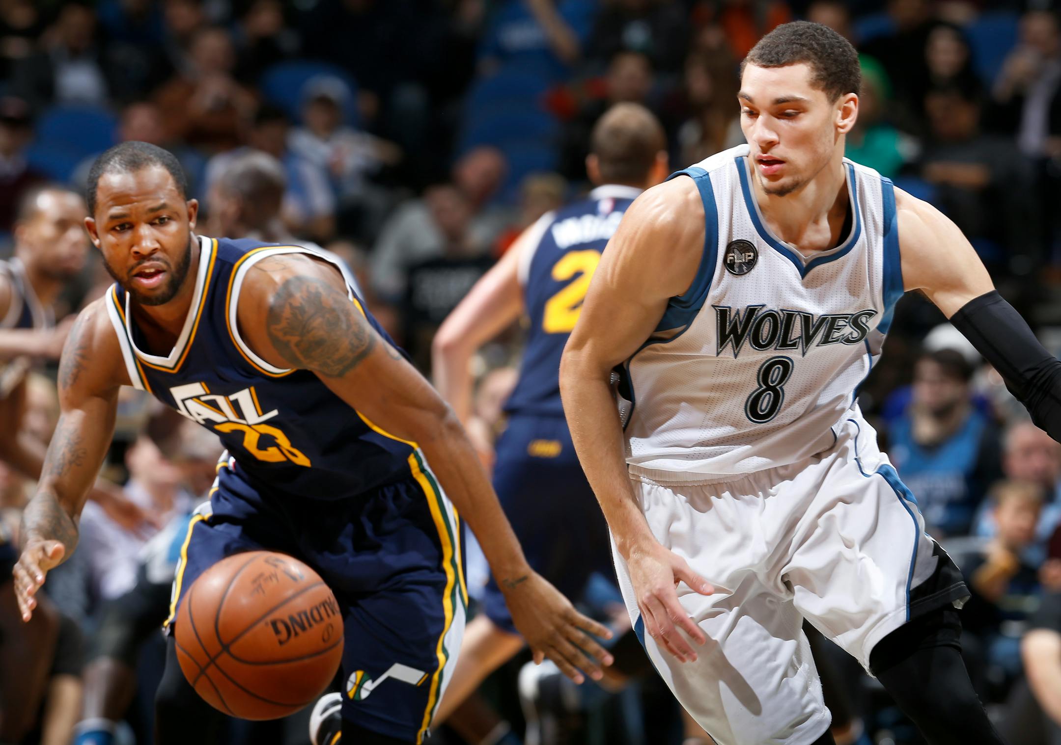 Chris Johnson (23) and Zach LaVine (8) chased a loose ball in the second quarter.