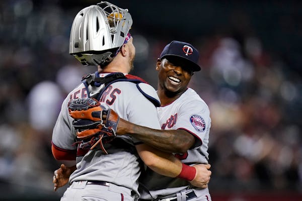 Twins relief pitcher Jharel Cotton smiles as he celebrates with catcher Ryan Jeffers after the final out of the game against the Diamondbacks last wee
