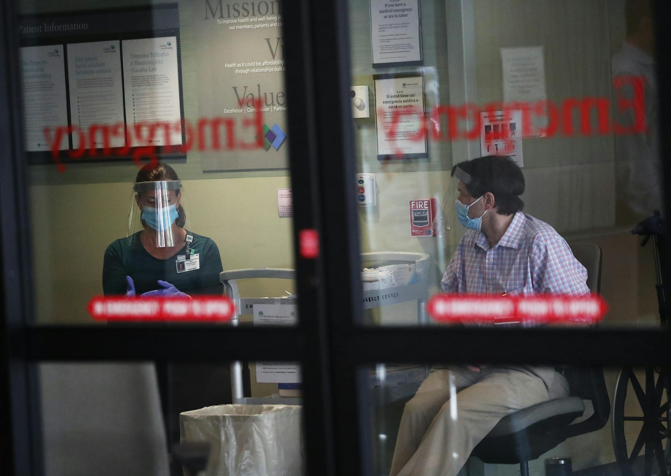 Screeners wait inside the entrance to the Park Nicollet Methodist Hospital emergency room, where they check those arriving for COVID symptoms before determining where they will go within the hospital and seen Thursday, June 4, 2020, in St. Louis Park, MN.] DAVID JOLES • david.joles@startribune.com Hospitals are urging people with medical emergencies to go to the ER again, but will anyone actually go? We're visiting hospital emergency departments in the Twin Cities this week to get a first-hand l