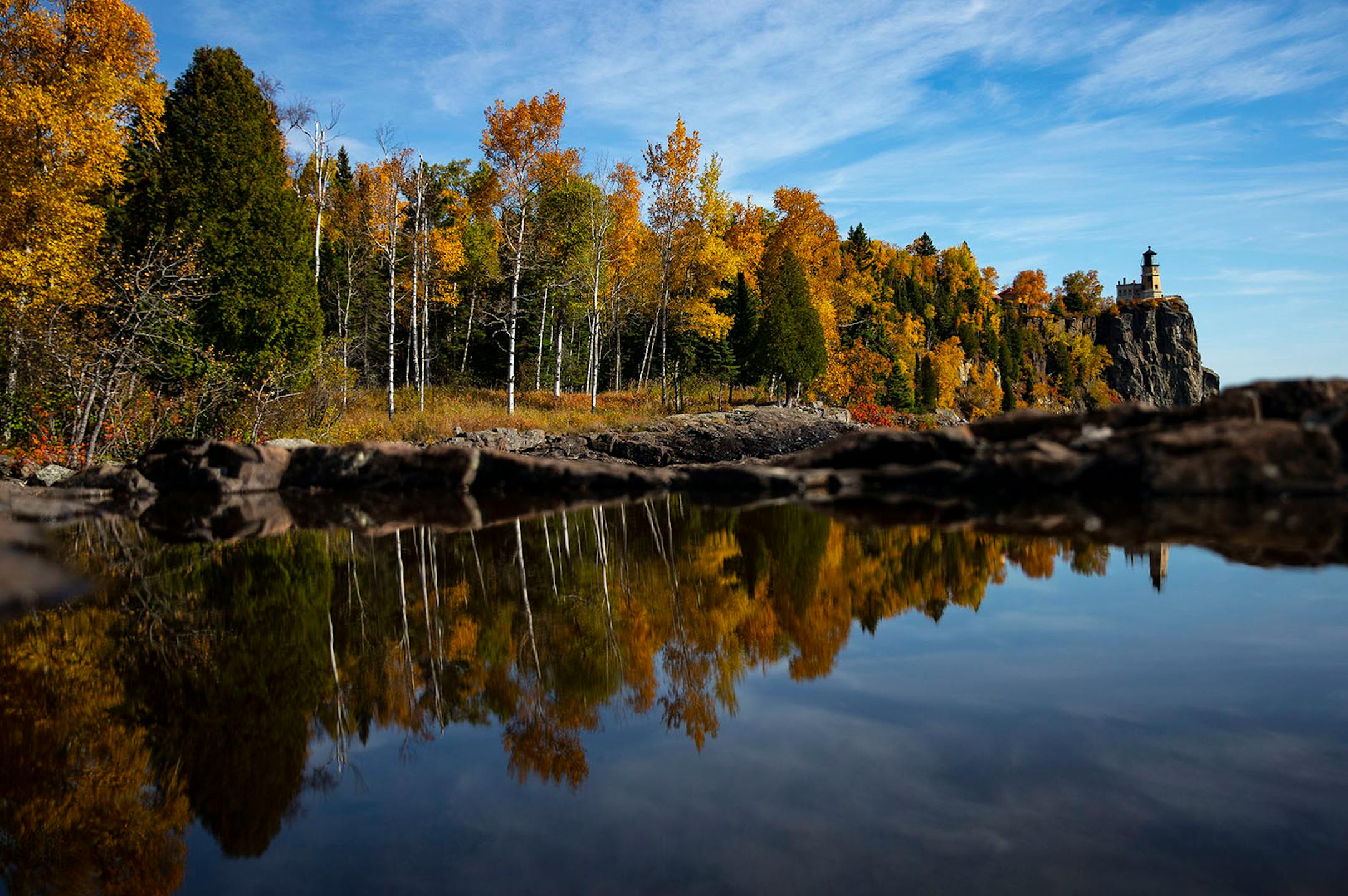 Split Rock Lighthouse was reflected in a small puddle of water beside Lake Superior in October 2019.